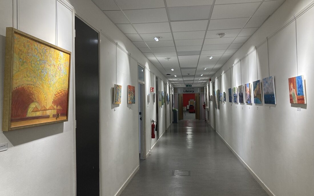 Photograph of the art corridor featuring Alla's paintings